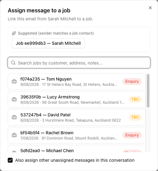 The Assign message to a job dialog, with a Suggested panel offering a one-click job match, a search box, a scrollable list of jobs showing reference, customer, date, address and status, and a ticked checkbox to also assign other unassigned messages in the conversation.